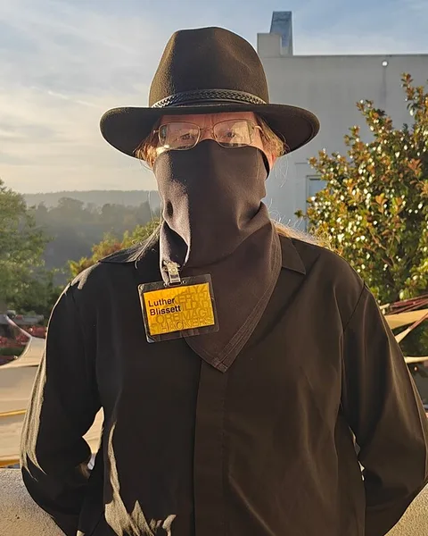 Eric Hughes: Eric Hughes, masked, with a pseudonym name tag